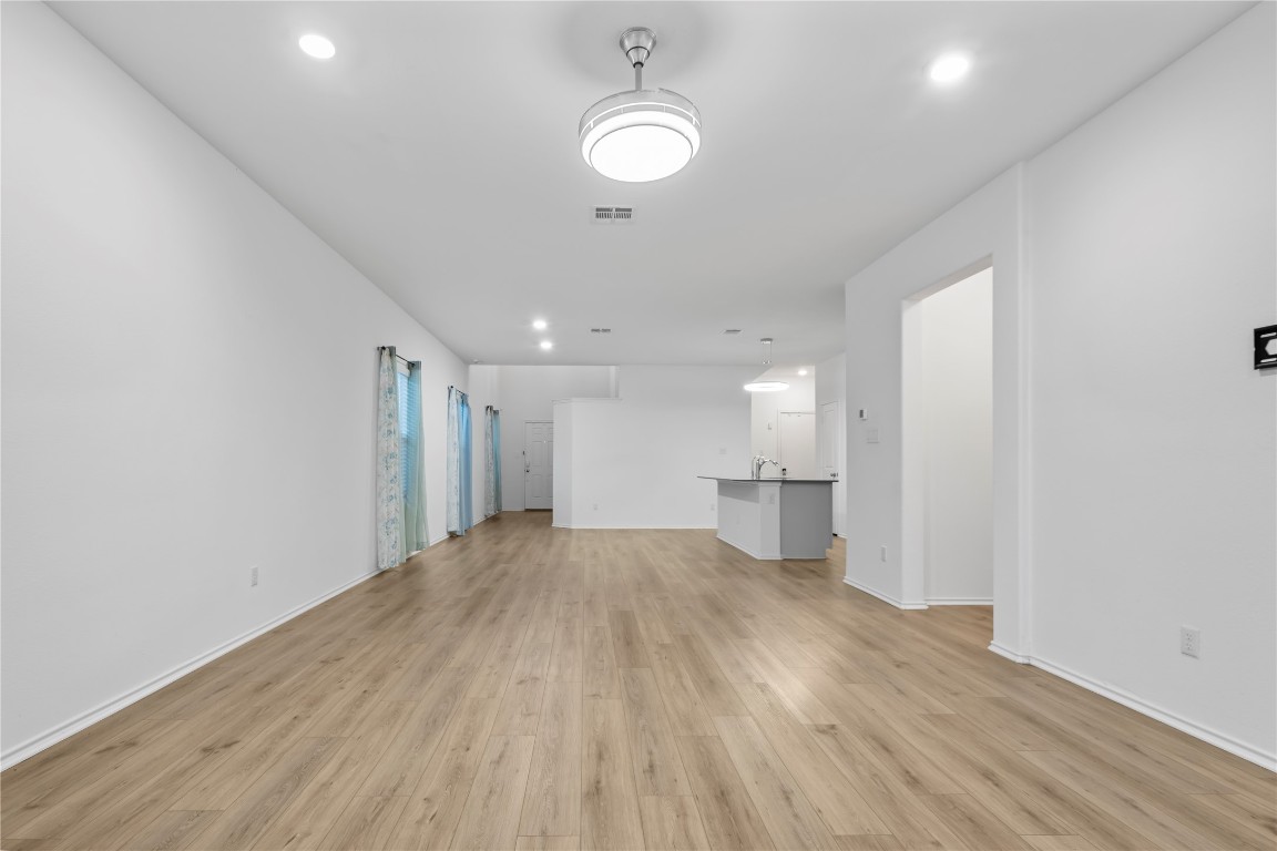 148 Rowdy Yates Way Jarrell, TX 76537 - Photo 8 of 39 a view of empty room with wooden floor