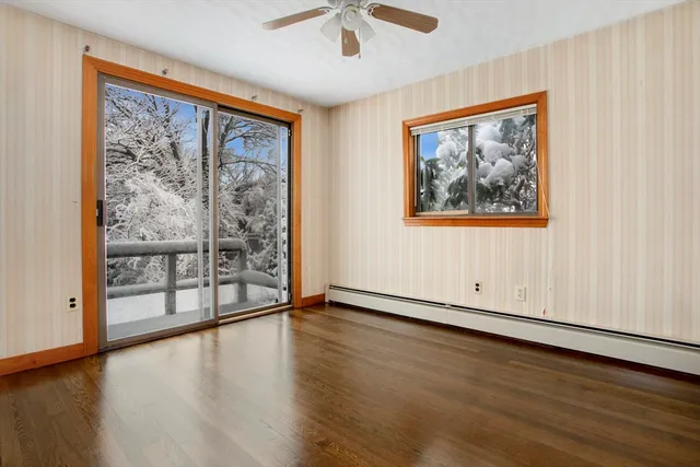 wooden floor in an empty room with a window