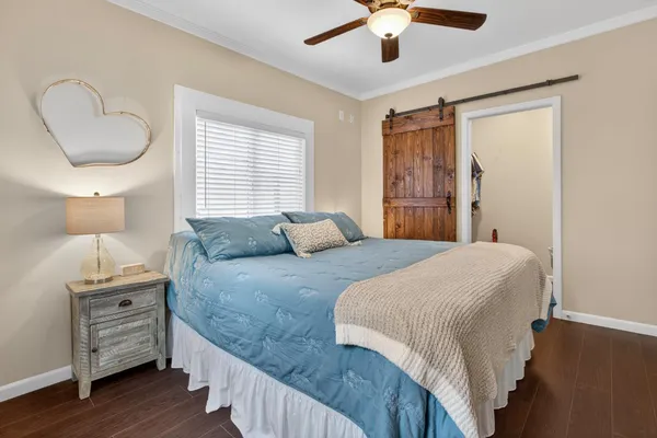 a bedroom with a large bed and a window