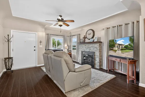 a living room with furniture a clock and a fireplace
