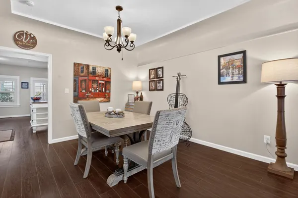 a view of a dining room with furniture wooden floor and chandelier