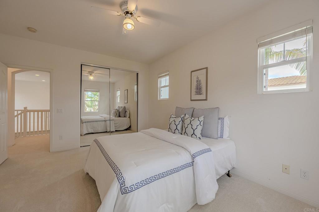 1370 Cassins Street Carlsbad, CA 92011 - Photo 19 of 35 a bedroom with a large bed and a chandelier