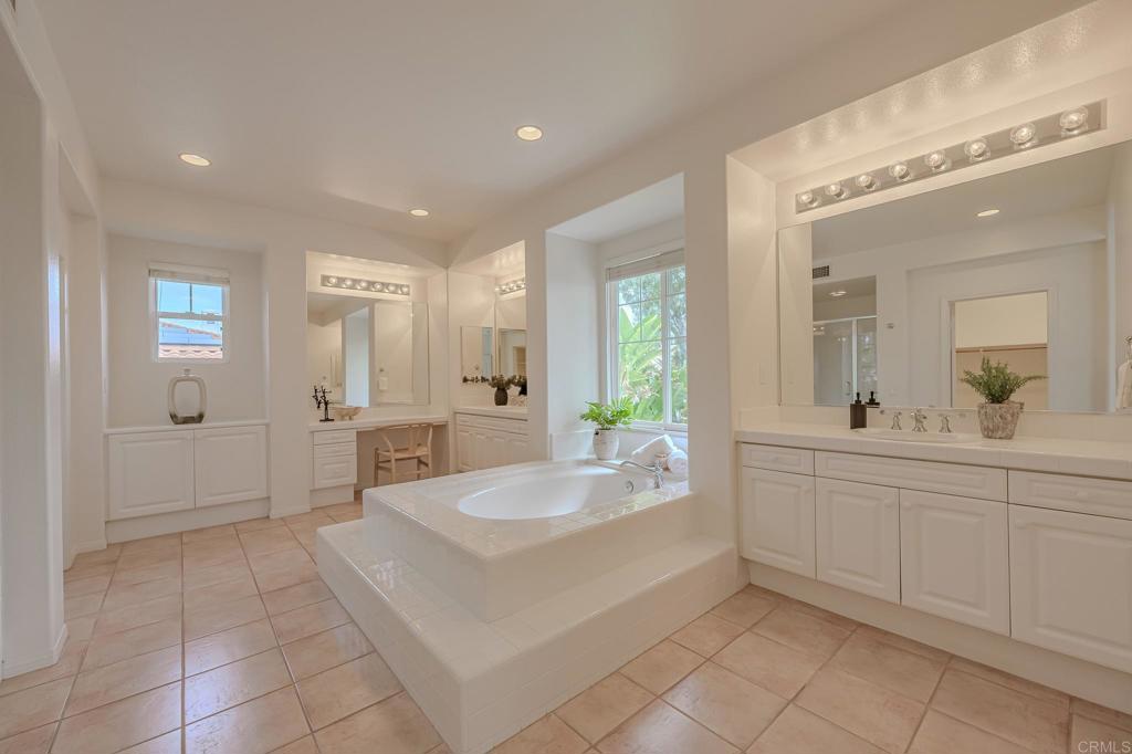 1370 Cassins Street Carlsbad, CA 92011 - Photo 7 of 35 a spacious bathroom with a tub sink and mirror