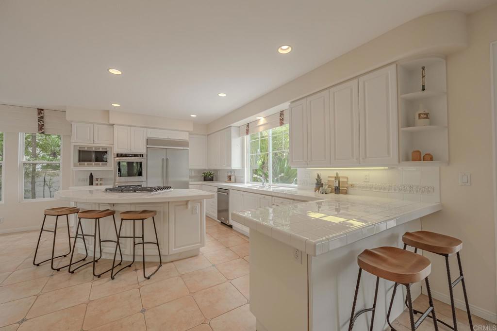 1370 Cassins Street Carlsbad, CA 92011 - Photo 9 of 35 a kitchen with a sink and chairs