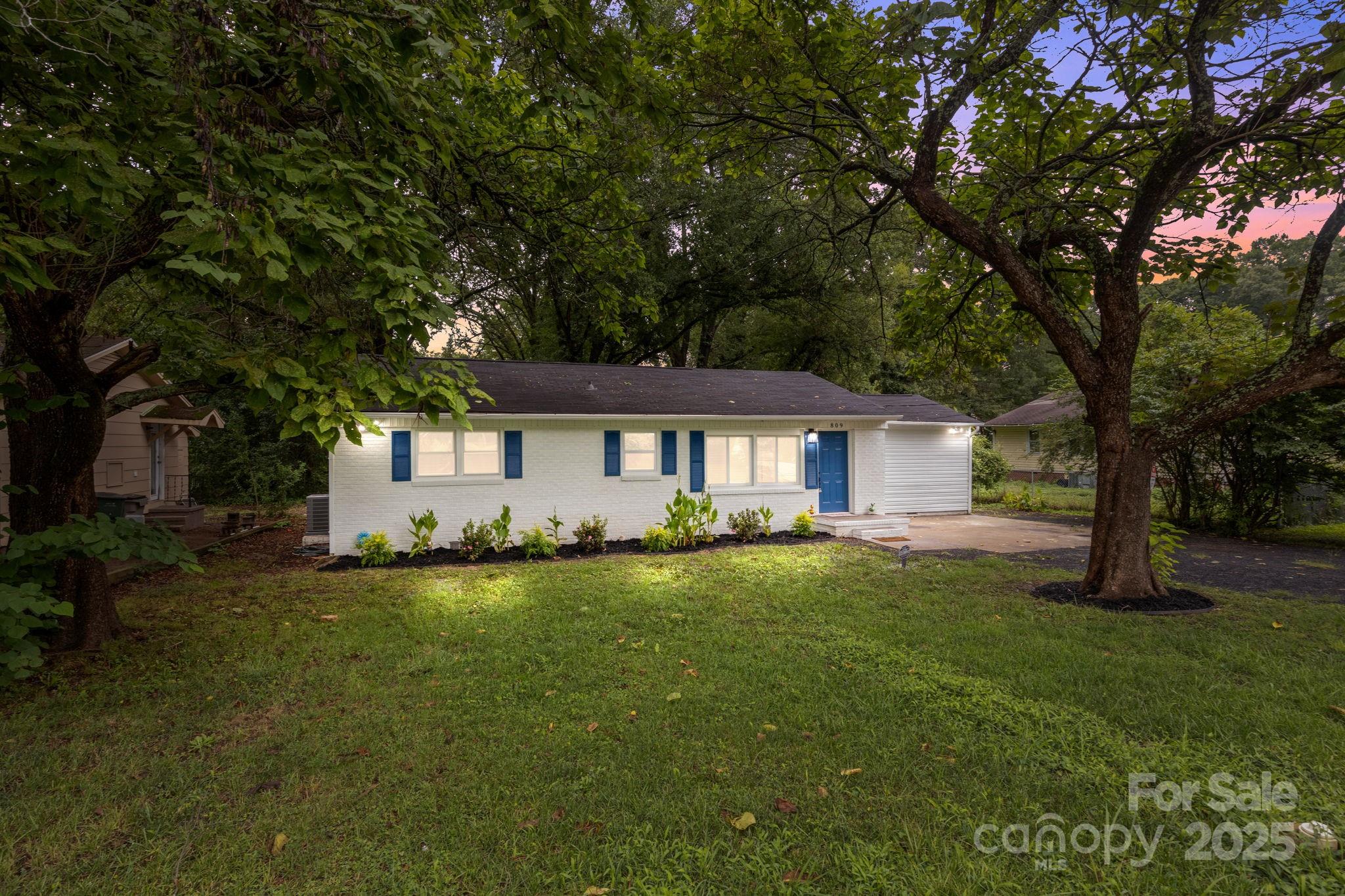 a front view of a house with a garden
