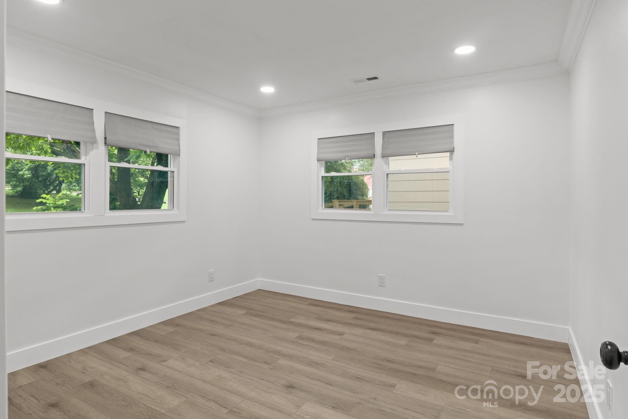 809 Miller Street Gastonia, NC 28052 - Photo 14 of 19 an empty room with wooden floor and windows