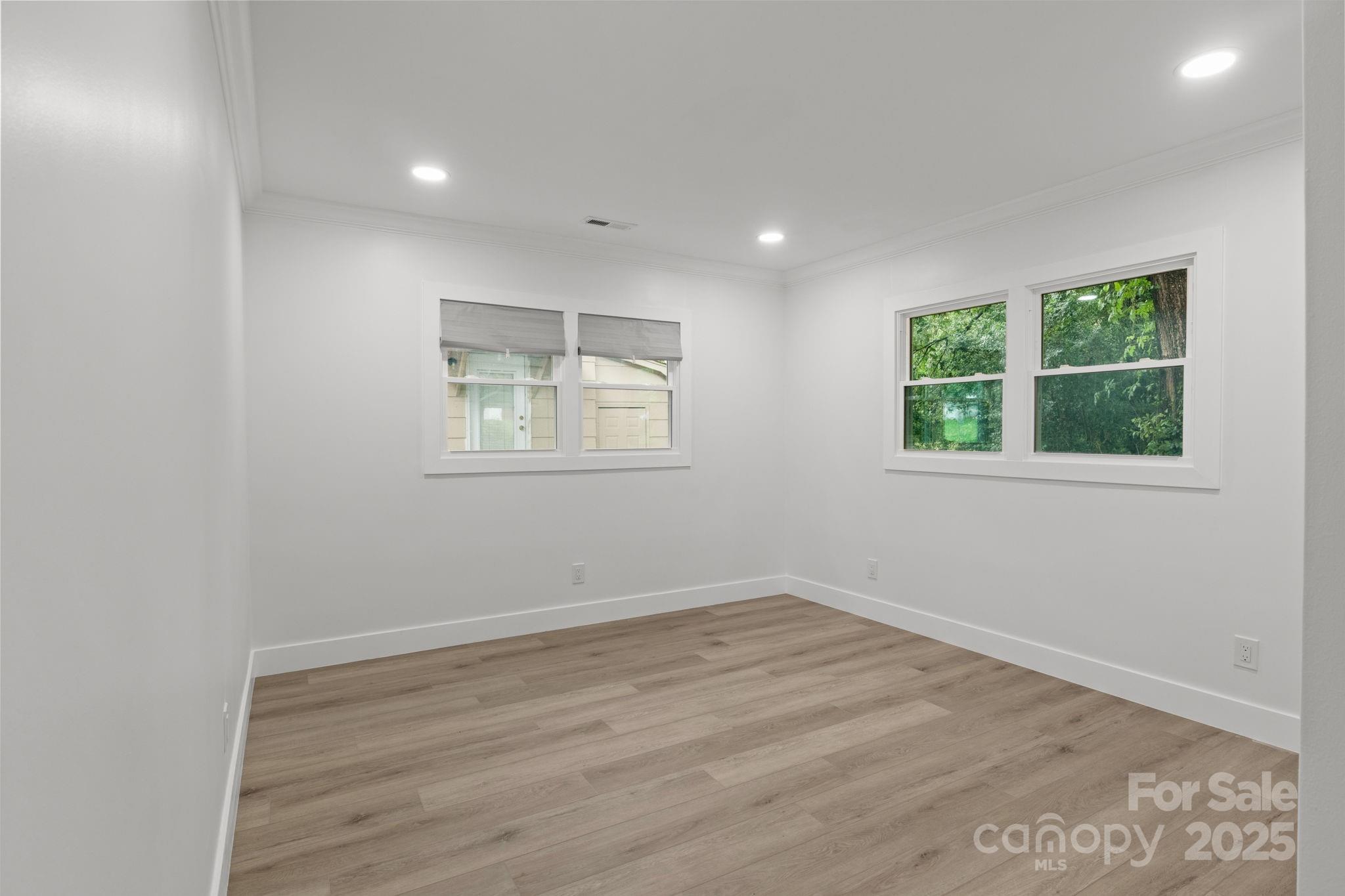 809 Miller Street Gastonia, NC 28052 - Photo 15 of 19 an empty room with wooden floor and windows