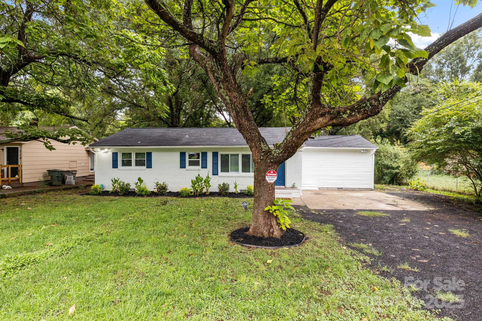 809 Miller Street Gastonia, NC 28052 - Photo 2 of 19 a front view of a house with a yard and garage
