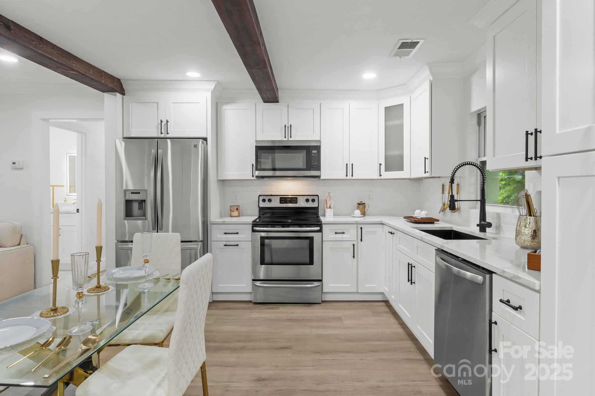 809 Miller Street Gastonia, NC 28052 - Photo 8 of 19 a kitchen with stainless steel appliances granite countertop a stove top oven a sink and a refrigerator