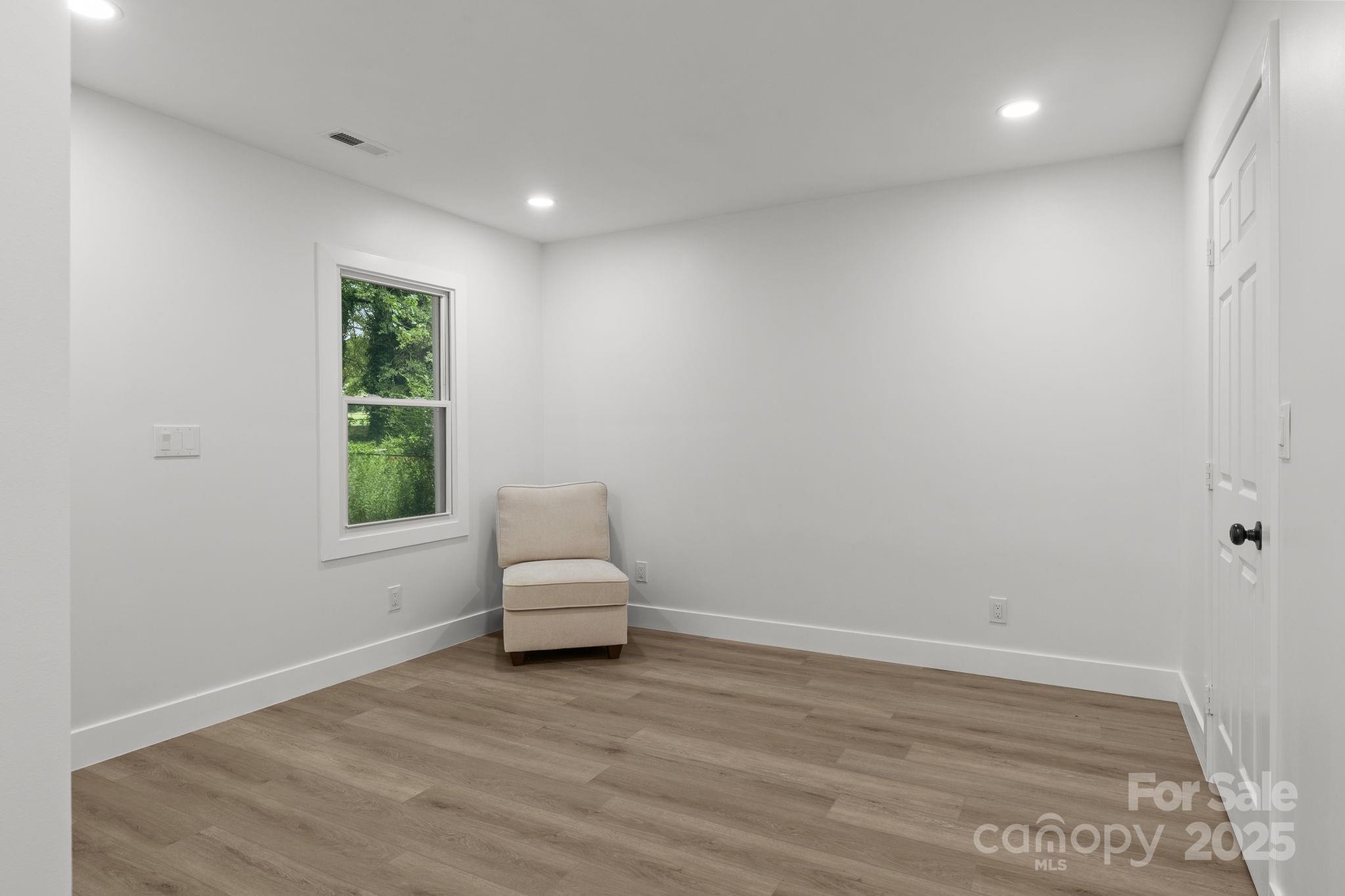 809 Miller Street Gastonia, NC 28052 - Photo 9 of 19 a view of empty room with wooden floor and fan