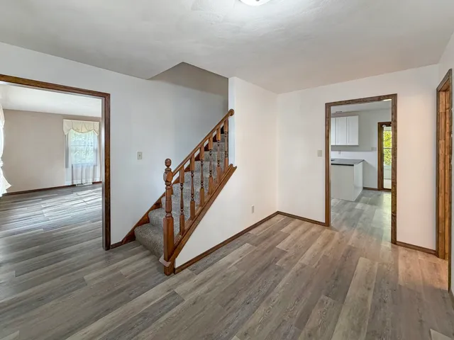 a view of an entryway with wooden floor