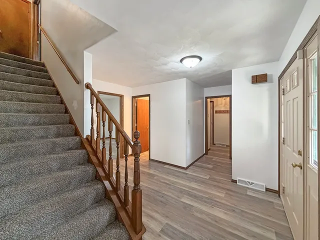 a view of entryway with wooden floor and stairs