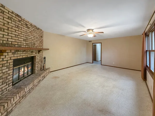 a view of an empty room with a fireplace