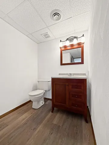 a bathroom with a toilet a sink and mirror