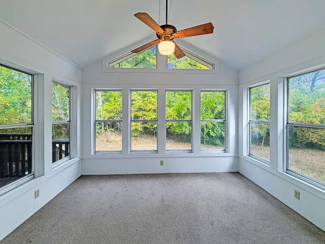 a view of room with a ceiling fan and window