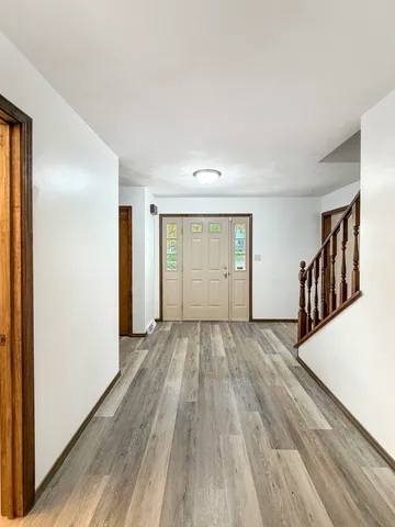a view of a livingroom with wooden floor and stairs
