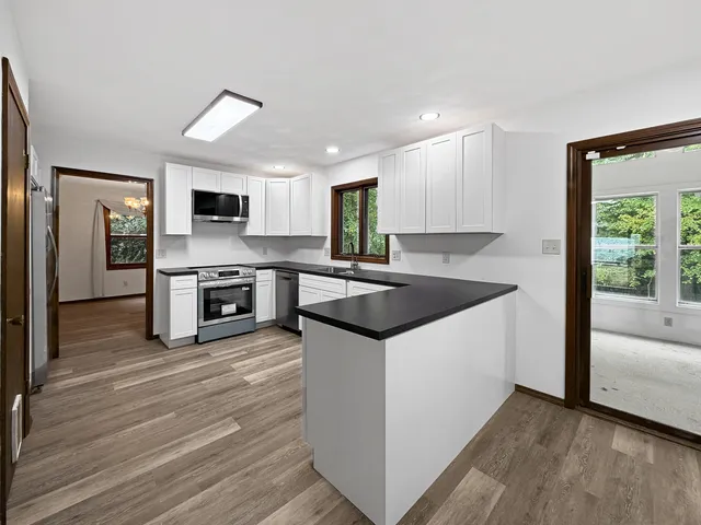 a kitchen with granite countertop a sink and a stove top oven