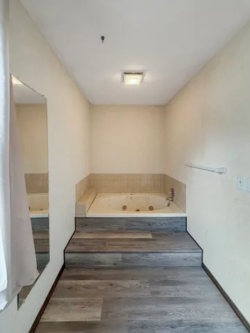 a view of entryway and hall with wooden floor