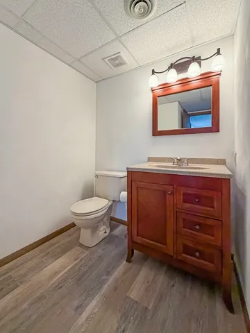 a bathroom with a toilet sink and mirror