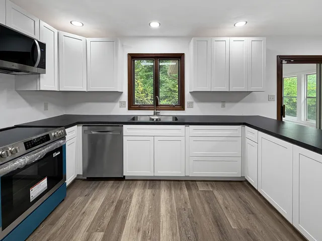 a kitchen with a sink stove and microwave