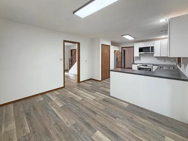 a kitchen with stainless steel appliances granite countertop a sink stove and cabinets