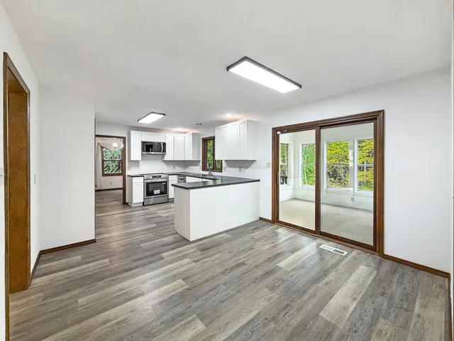 a view of kitchen with wooden floor
