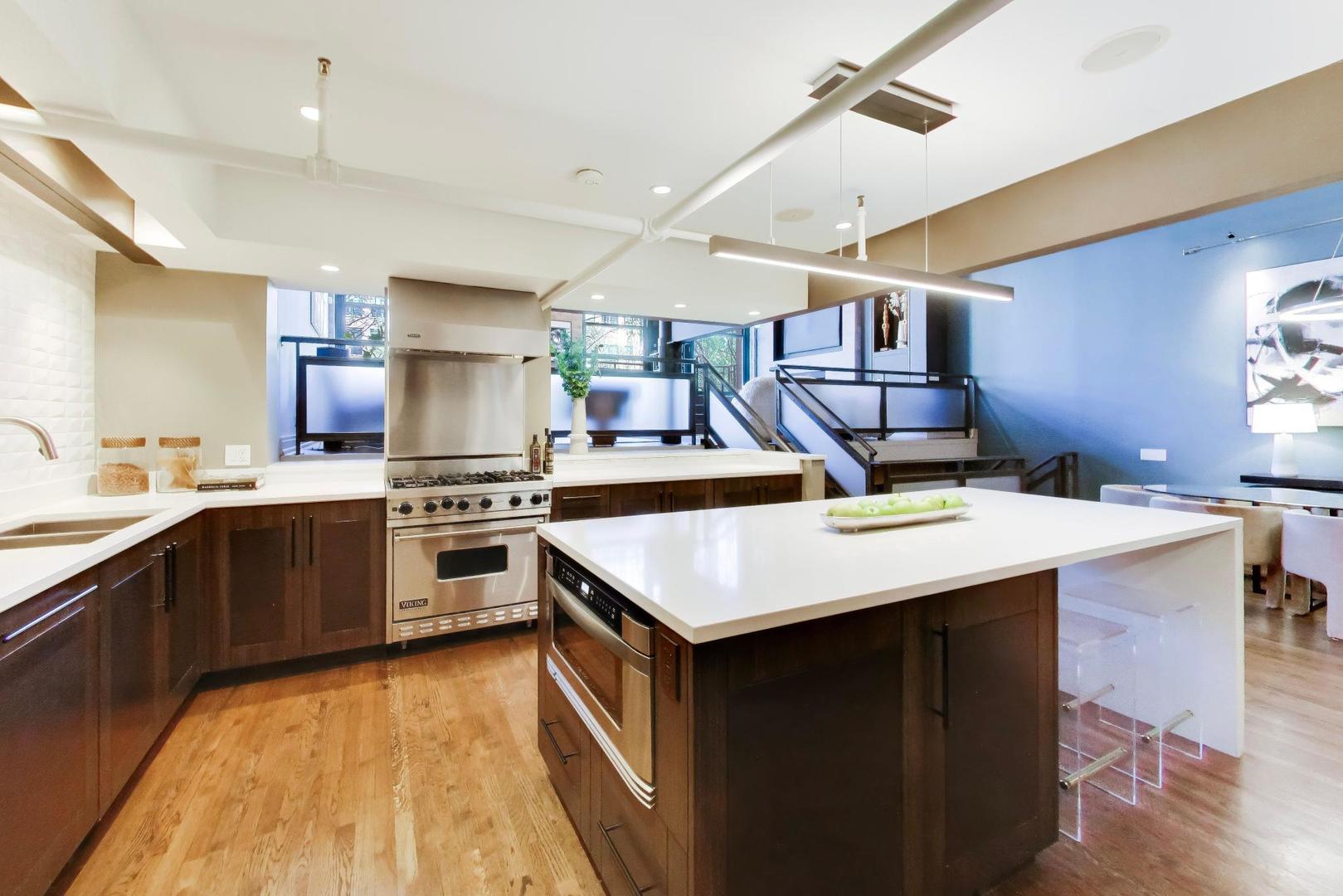 1000 West Washington Boulevard, Unit 145 Chicago, IL 60607 - Photo 11 of 45 a kitchen with a stove a sink dishwasher and a refrigerator