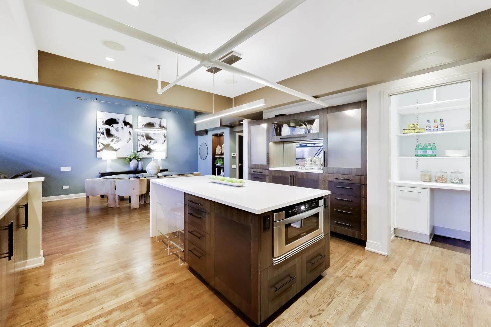 1000 West Washington Boulevard, Unit 145 Chicago, IL 60607 - Photo 12 of 45 a kitchen with a stove and cabinets