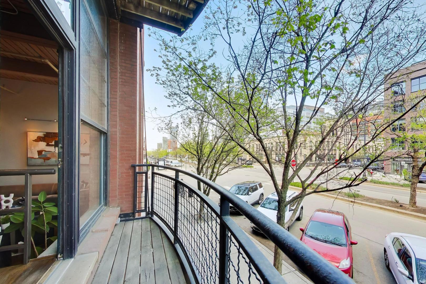 1000 West Washington Boulevard, Unit 145 Chicago, IL 60607 - Photo 15 of 45 a view of balcony with wooden floor and large trees