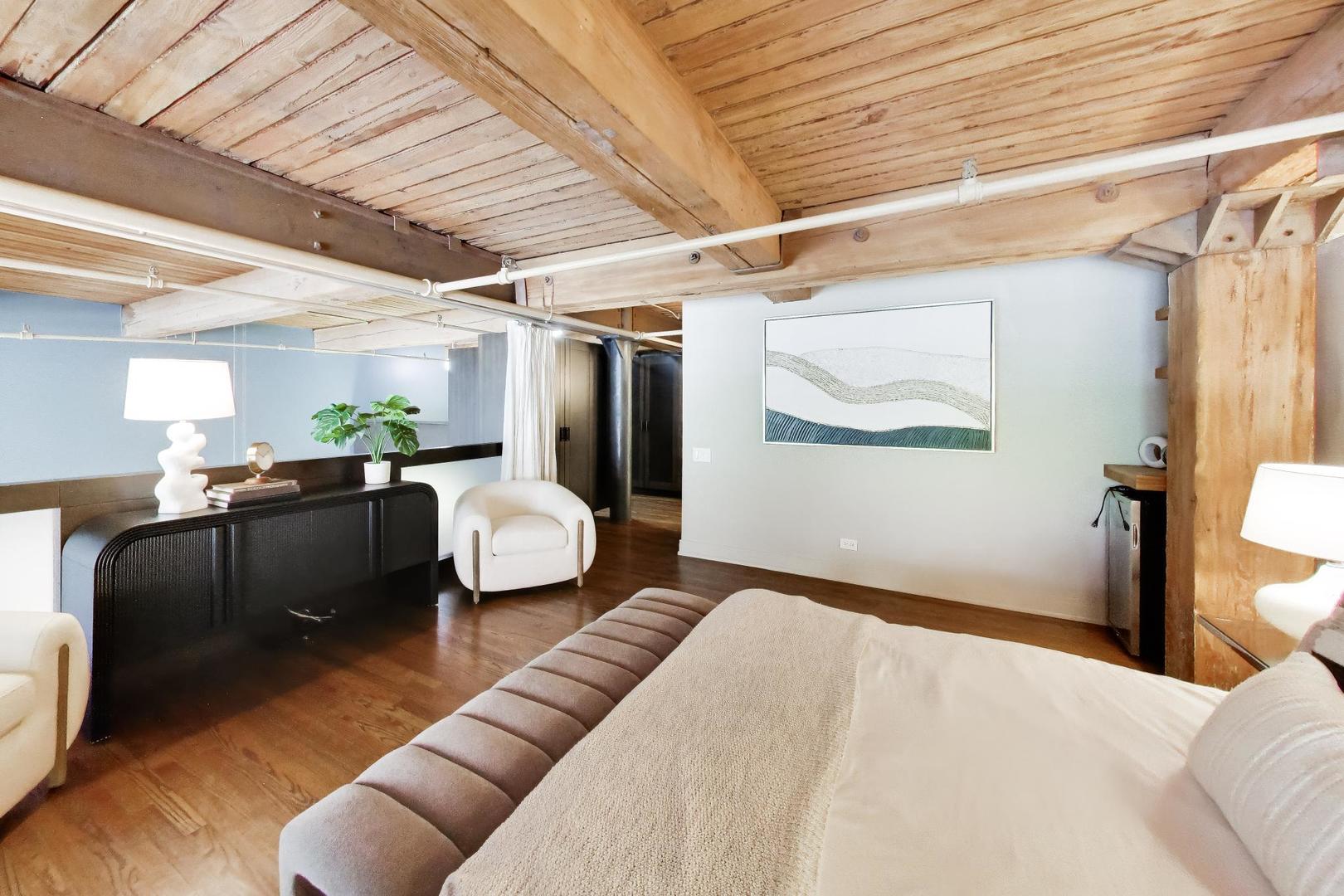 1000 West Washington Boulevard, Unit 145 Chicago, IL 60607 - Photo 19 of 45 a bedroom with furniture and a wooden floor