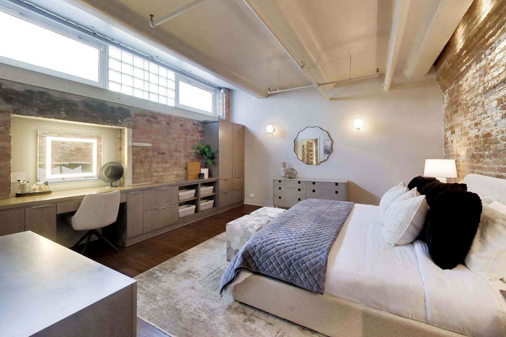 1000 West Washington Boulevard, Unit 145 Chicago, IL 60607 - Photo 26 of 45 a bedroom with a large bed and wooden floor