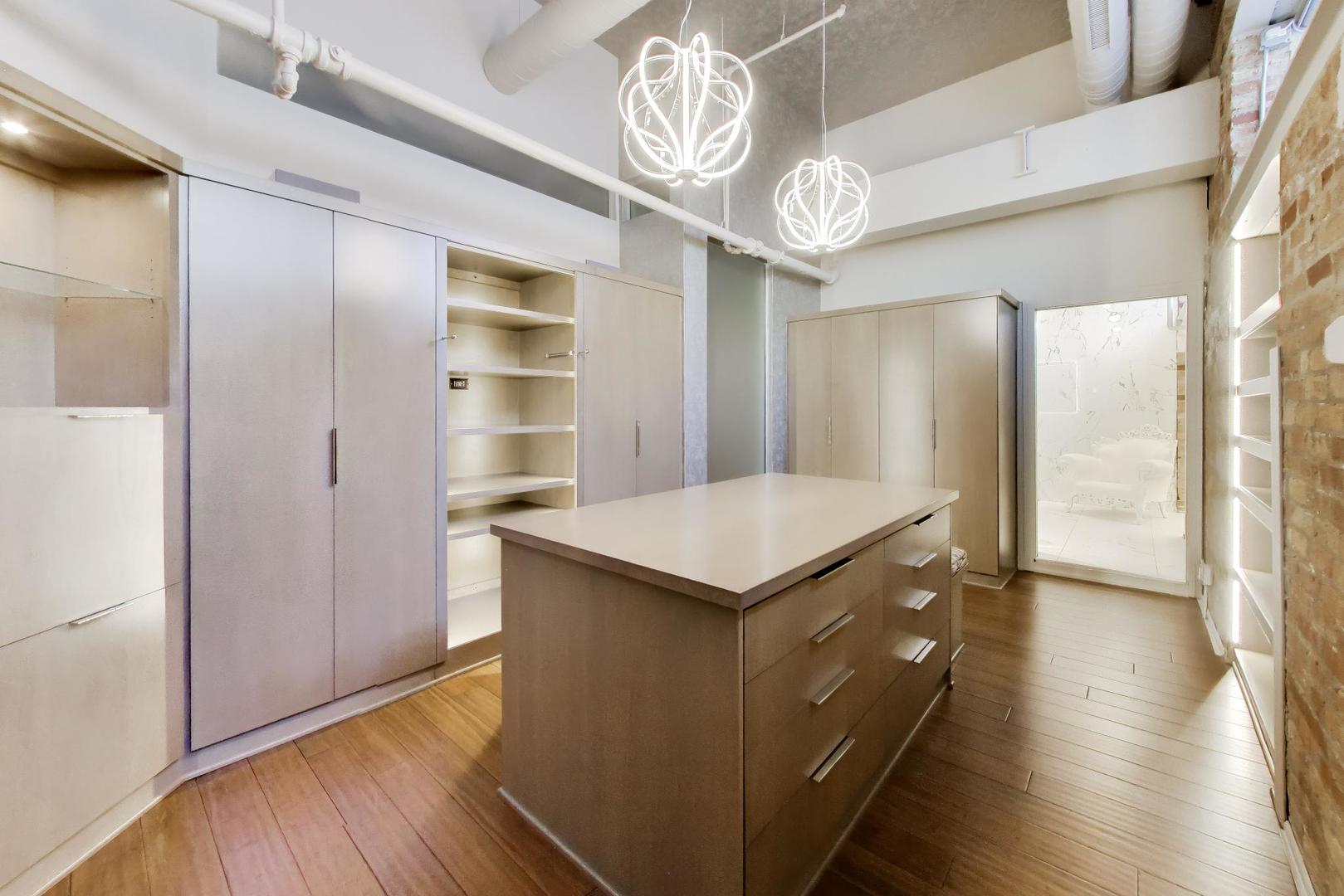 1000 West Washington Boulevard, Unit 145 Chicago, IL 60607 - Photo 29 of 45 a kitchen with a refrigerator and countertop wooden floor