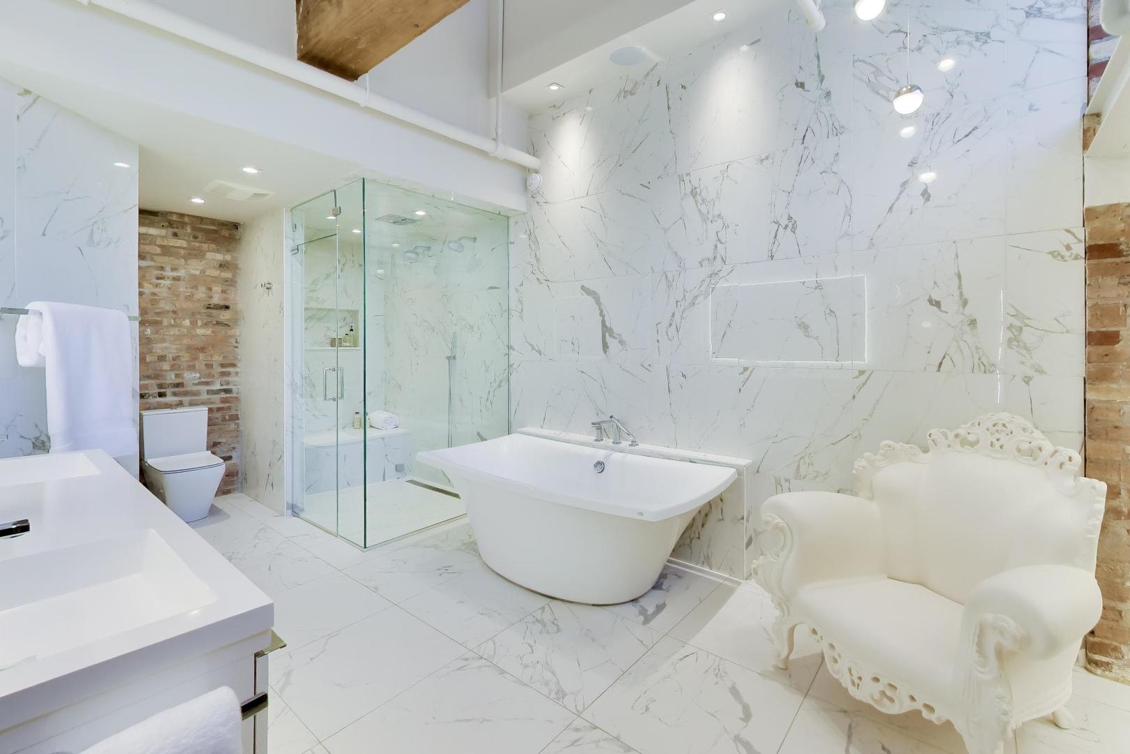 1000 West Washington Boulevard, Unit 145 Chicago, IL 60607 - Photo 31 of 45 a spacious bathroom with a bathtub shower sink and toilet