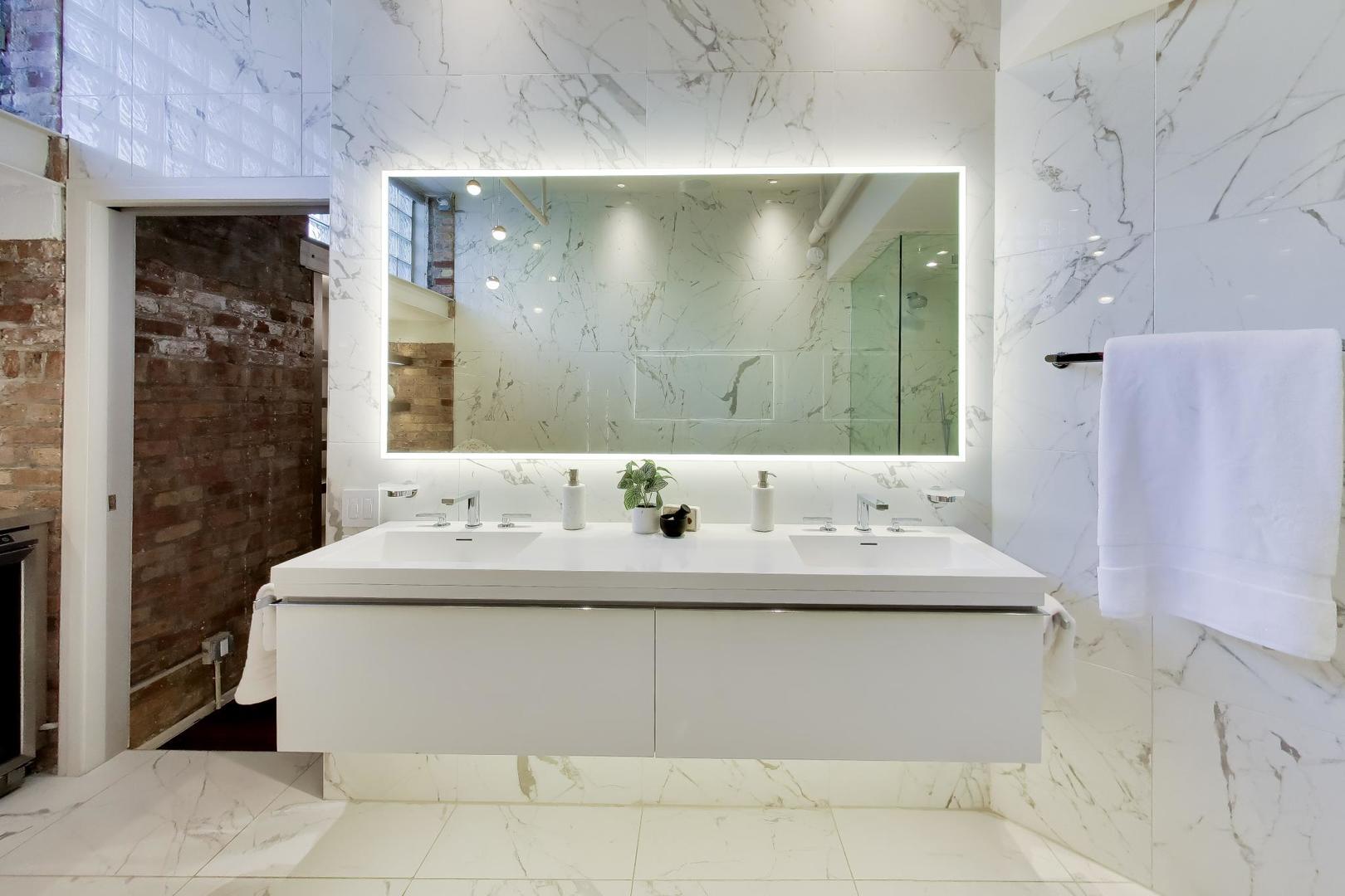 1000 West Washington Boulevard, Unit 145 Chicago, IL 60607 - Photo 32 of 45 a bathroom with a double vanity sink mirror and shower