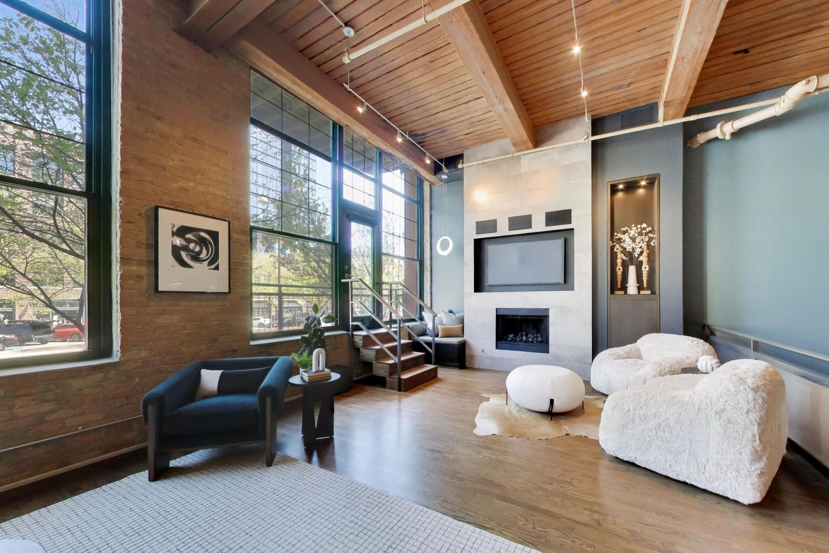 1000 West Washington Boulevard, Unit 145 Chicago, IL 60607 - Photo 6 of 45 a living room with furniture a fireplace and a floor to ceiling window