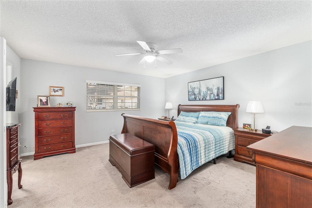 8889 Southwest 96th Street, Unit E Ocala, FL 34481 - Photo 20 of 40 a spacious bedroom with a bed and a cabinets