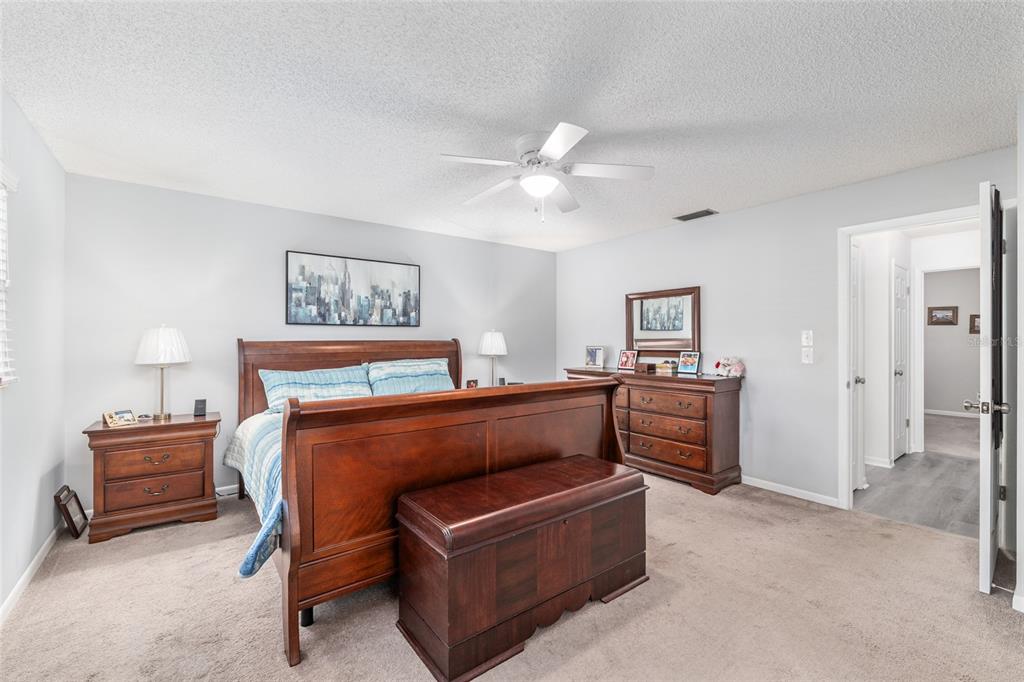 8889 Southwest 96th Street, Unit E Ocala, FL 34481 - Photo 21 of 40 a bedroom with furniture and a ceiling fan