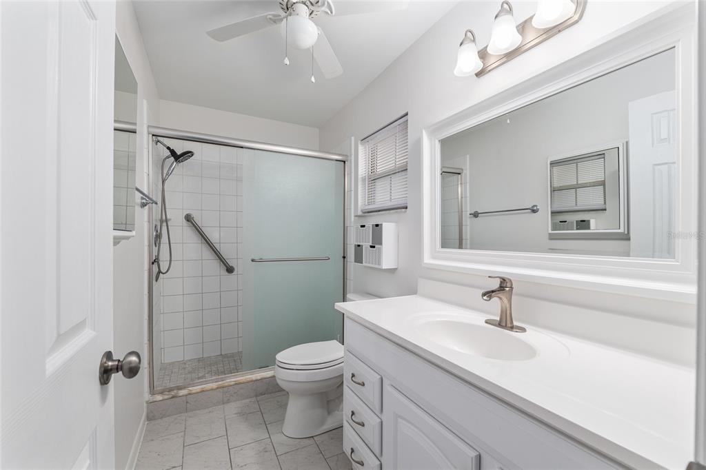 8889 Southwest 96th Street, Unit E Ocala, FL 34481 - Photo 23 of 40 a bathroom with a sink toilet and shower