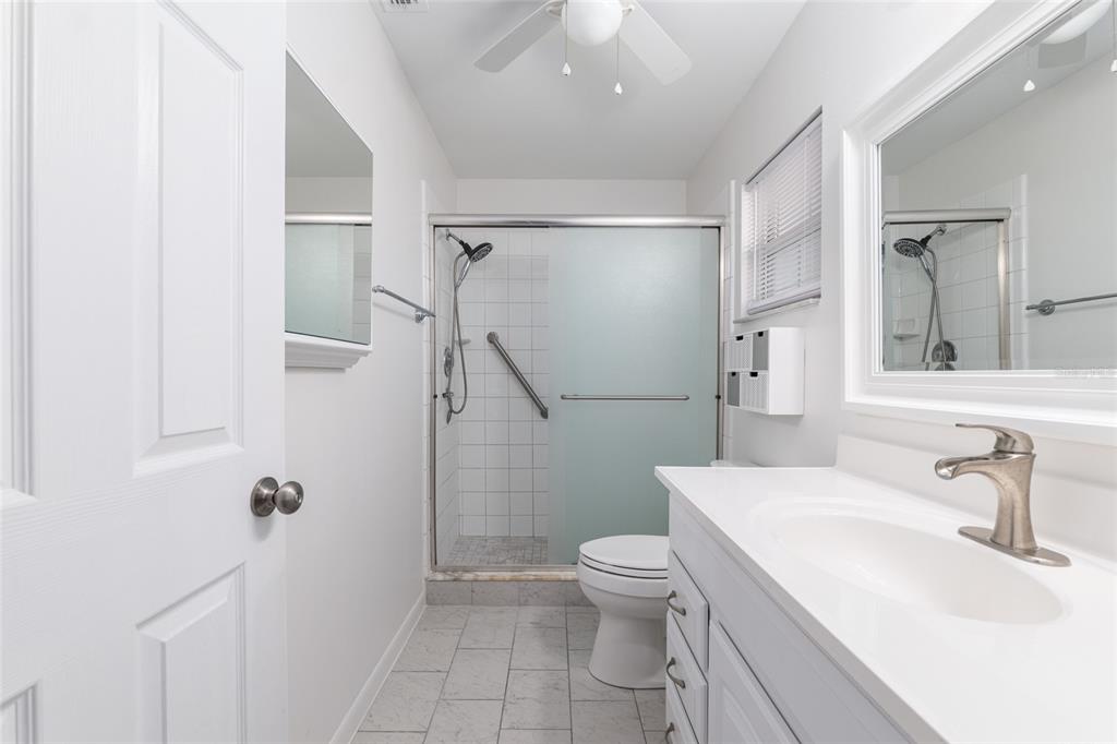 8889 Southwest 96th Street, Unit E Ocala, FL 34481 - Photo 24 of 40 a bathroom with a sink toilet and shower