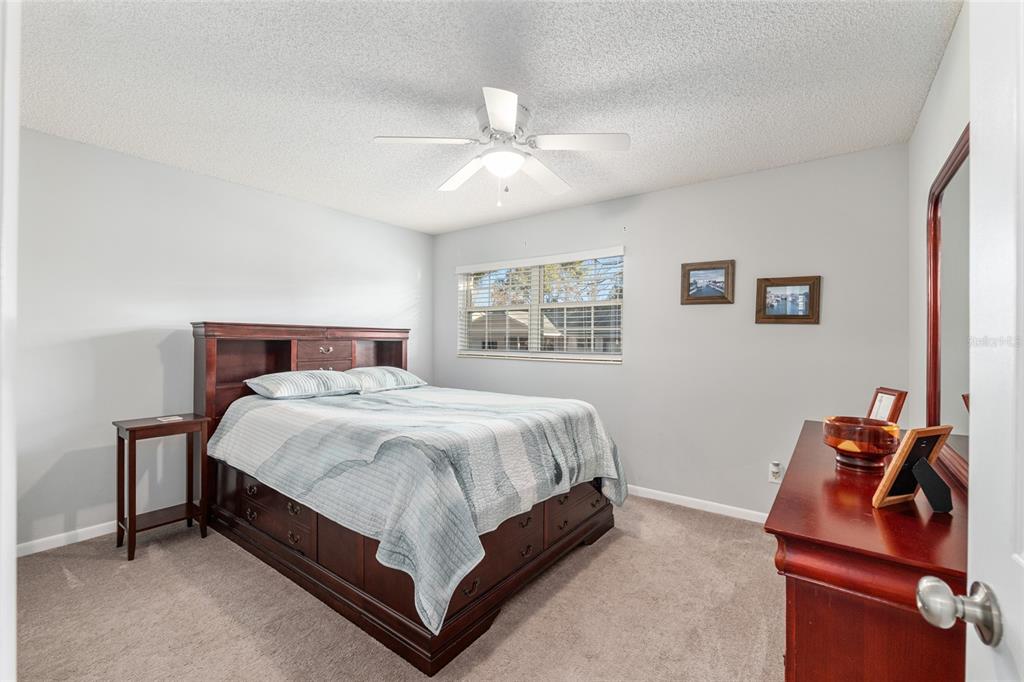 8889 Southwest 96th Street, Unit E Ocala, FL 34481 - Photo 26 of 40 a bed sitting in a bedroom next to a window