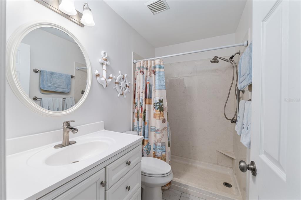 8889 Southwest 96th Street, Unit E Ocala, FL 34481 - Photo 28 of 40 a bathroom with a sink a toilet and shower
