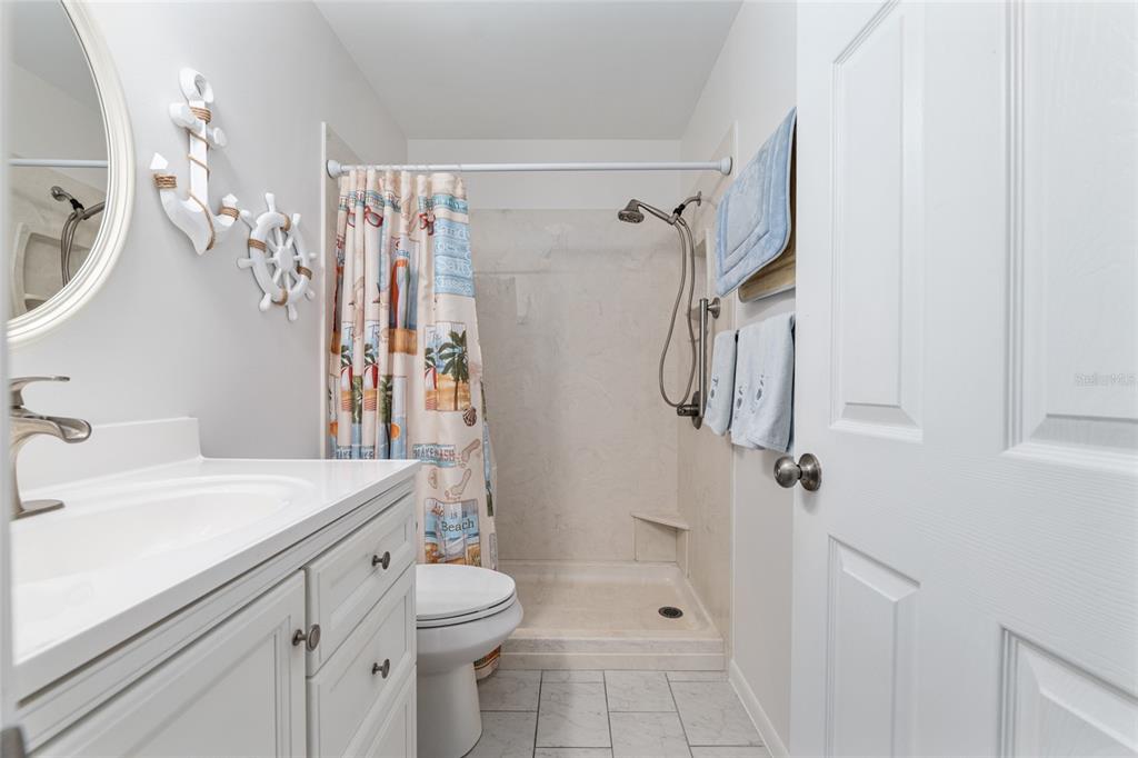 8889 Southwest 96th Street, Unit E Ocala, FL 34481 - Photo 29 of 40 a bathroom with a sink a toilet and shower