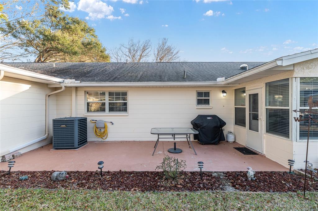 8889 Southwest 96th Street, Unit E Ocala, FL 34481 - Photo 34 of 40 a front view of a house with garden
