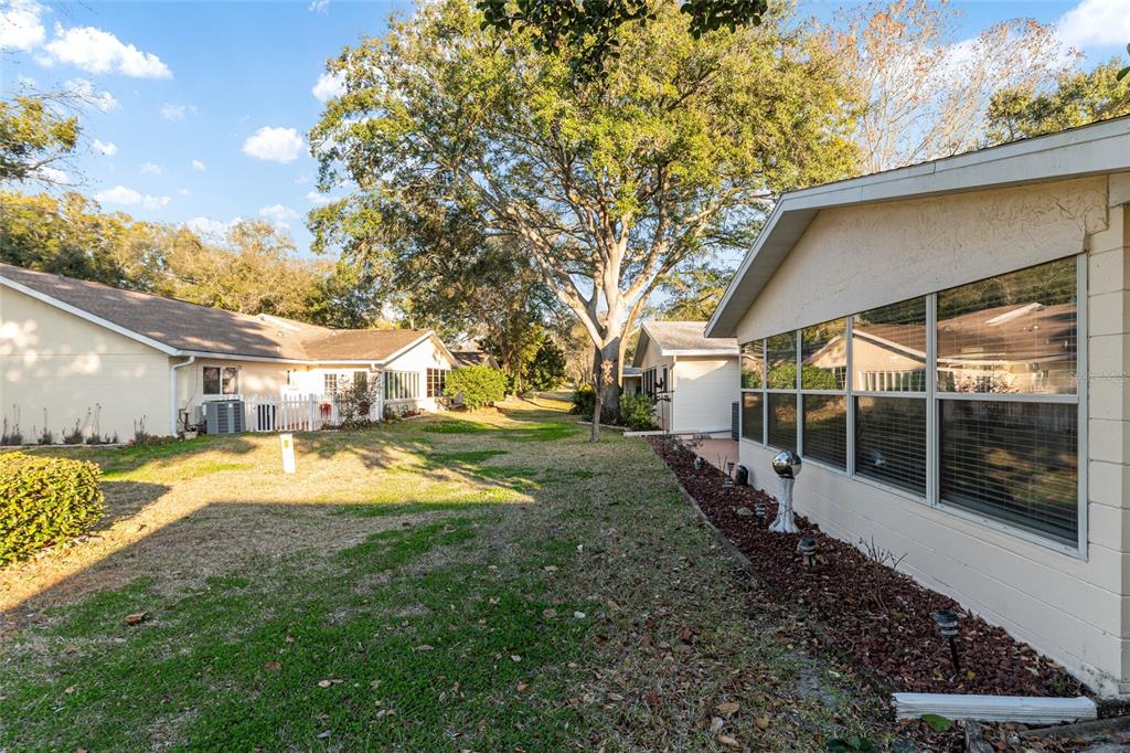 8889 Southwest 96th Street, Unit E Ocala, FL 34481 - Photo 36 of 40 a view of a house with a yard