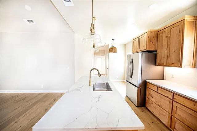 a kitchen with granite countertop white cabinets and stainless steel appliances