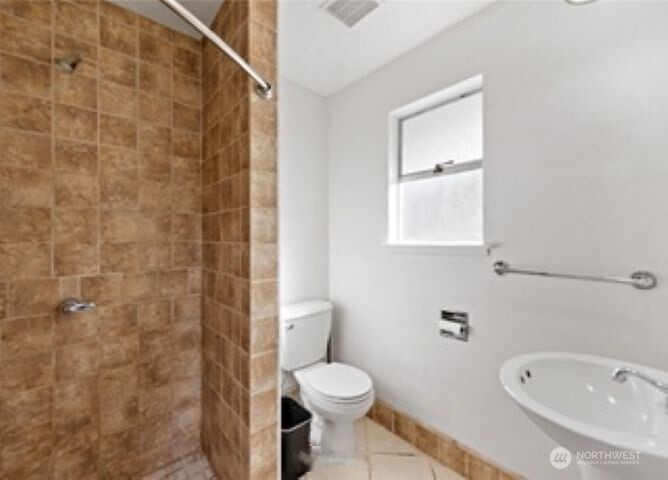 10601 55th Avenue South Seattle, WA 98178 - Photo 13 of 26 a bathroom with a toilet and a sink