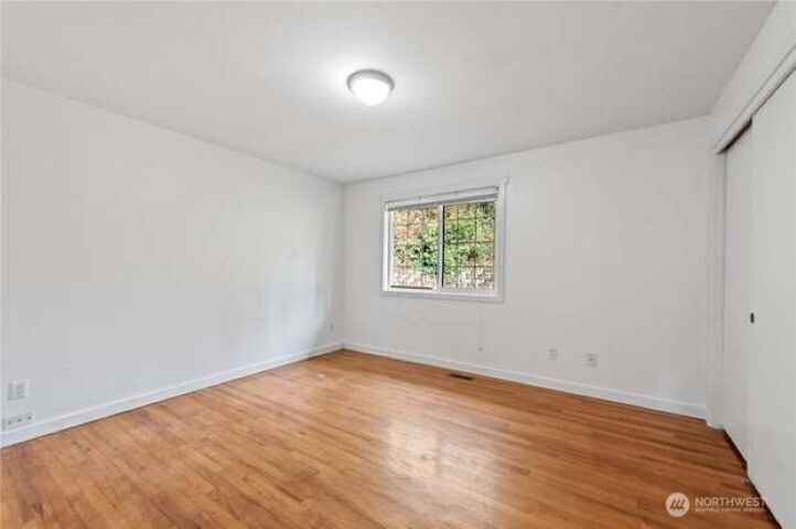 10601 55th Avenue South Seattle, WA 98178 - Photo 18 of 26 an empty room with wooden floor and window