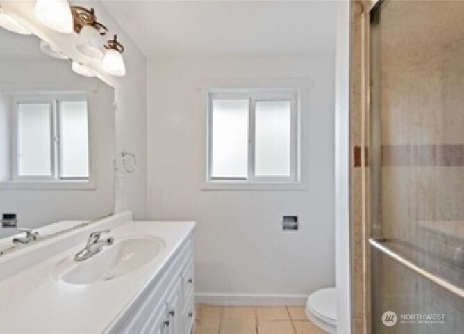 10601 55th Avenue South Seattle, WA 98178 - Photo 21 of 26 a bathroom with a sink a toilet and shower