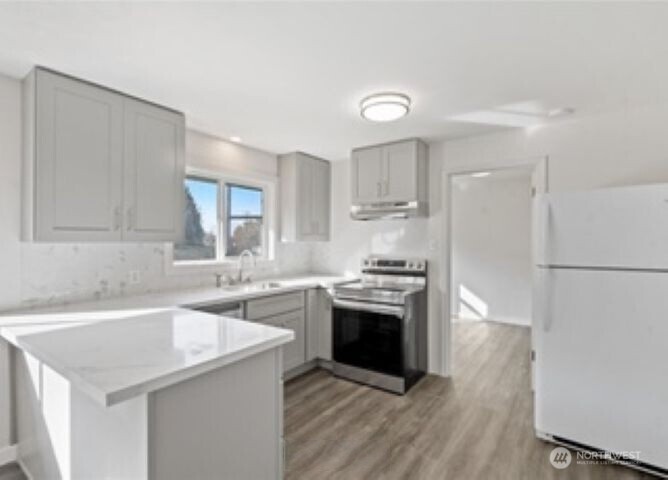 10601 55th Avenue South Seattle, WA 98178 - Photo 9 of 26 a kitchen with stainless steel appliances granite countertop a sink stove and refrigerator