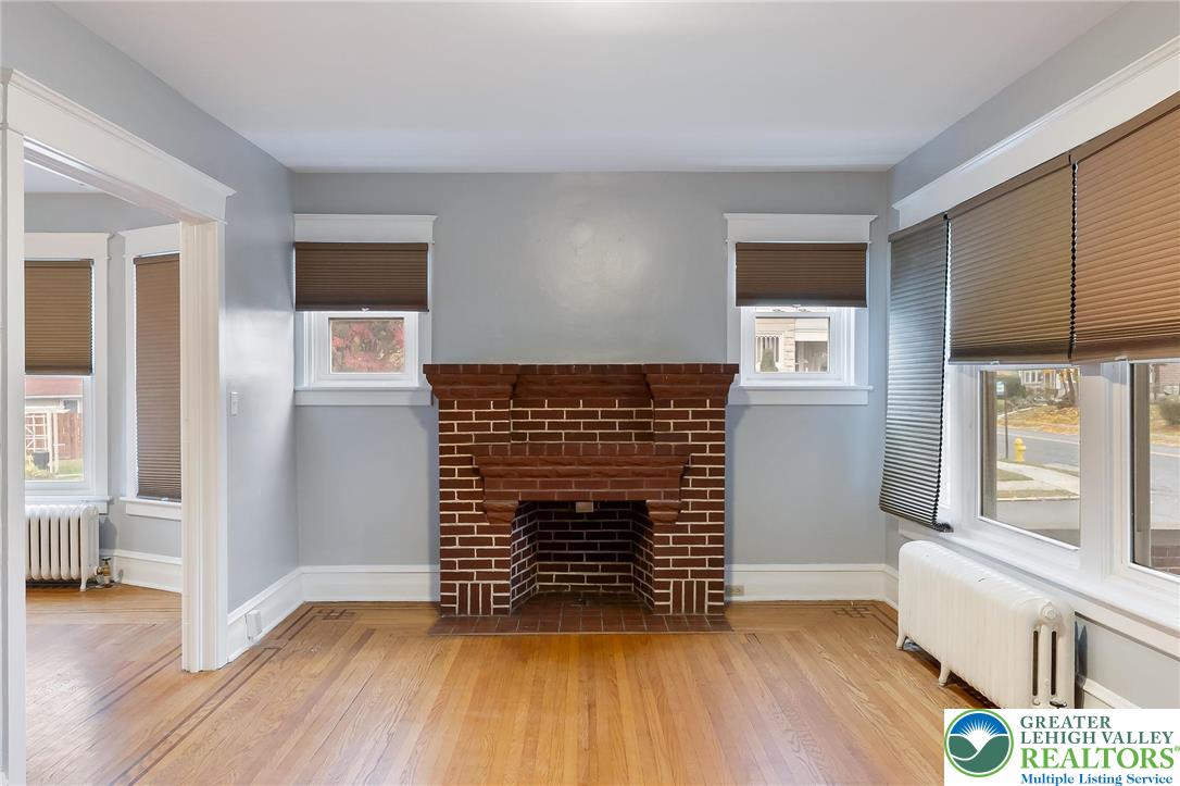 1150 North 19th Street, Unit 1 Allentown, PA 18104 - Photo 15 of 32 a view of an empty room with wooden floor and a window